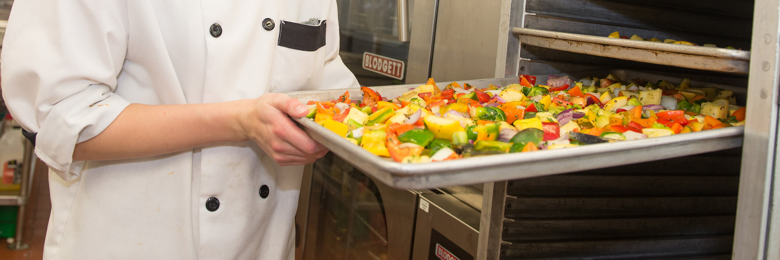 ISU Campus Dining Service Worker with a trail of vegetables